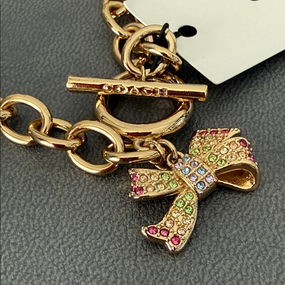 Coach Gold Bracelet with Multicolor Gem Encrusted Bow Charm New in Box - Picture 2 of 7